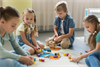 front-view-children-playing-together-in-kindergarten